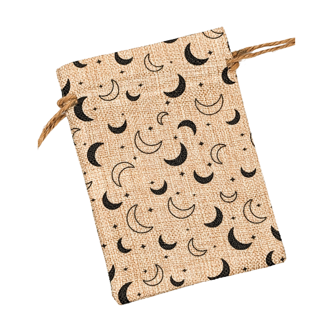 a drawstring burlap bag with an all over black crescent moon design